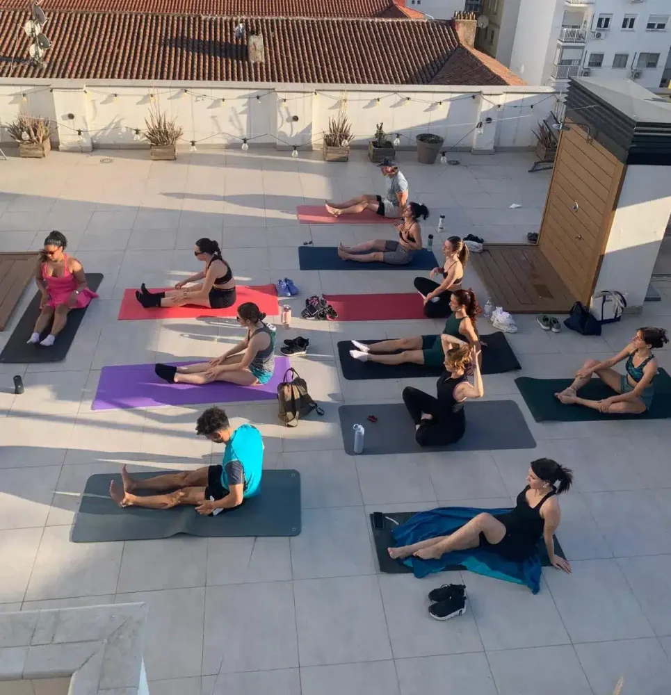 Rooftop pilates class at Urban Campus in Madrid, residents enjoying a shared workout session