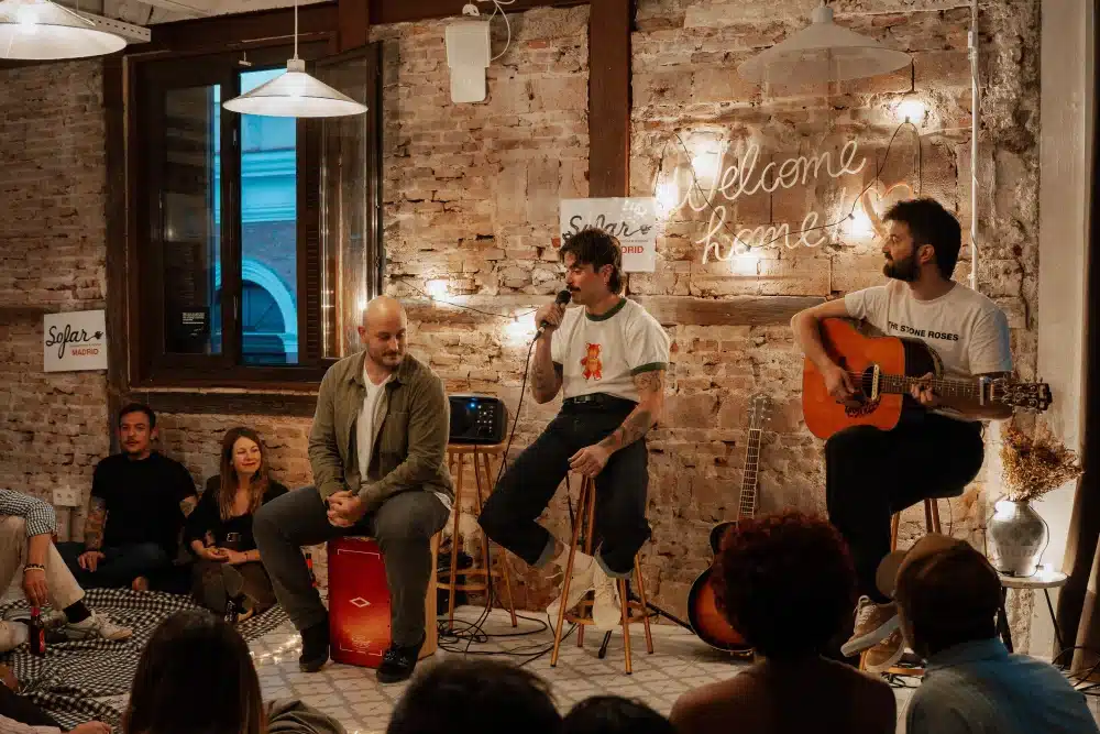 Acoustic trio performing at a Sofar Sounds session in the Urban Campus community space in Madrid