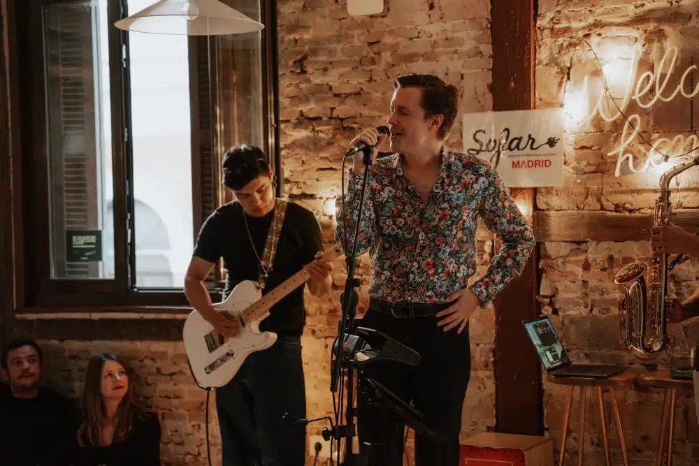 Singer performing with the band at a Sofar Sounds session in the Urban Campus community space in Madrid
