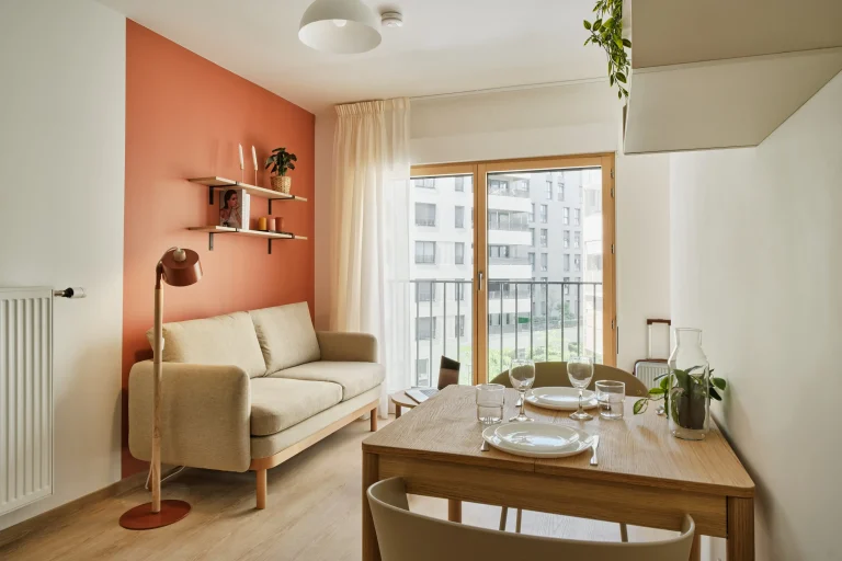 Living and dining area with street view in a studio at Urban Campus Confluences