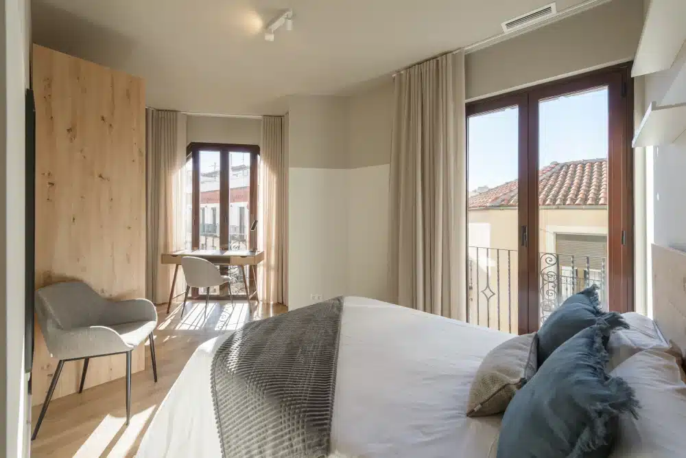 Bedroom with desk and rooftop view at Urban Campus Avenida América Coliving in Madrid
