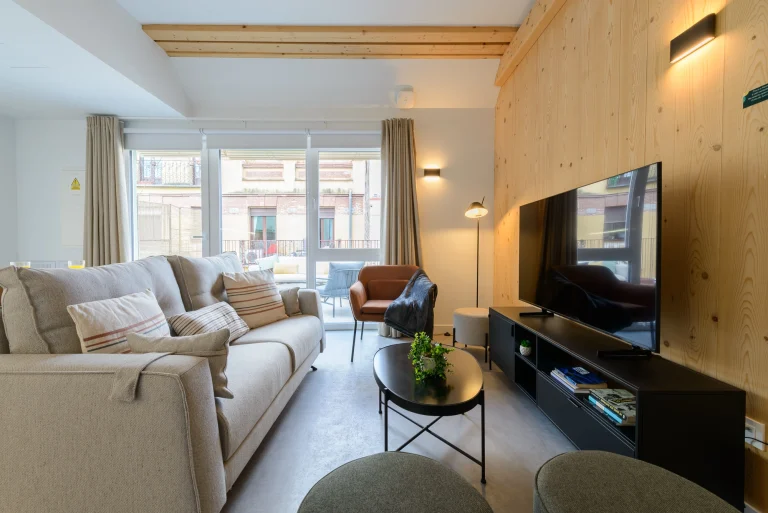 Apartment living room with balcony access at Urban Campus Cuatro Caminos, Coliving in Madrid