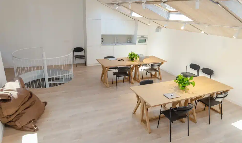 Coworking area at Urban Campus Malasaña Madrid, shared desks and skylight roof