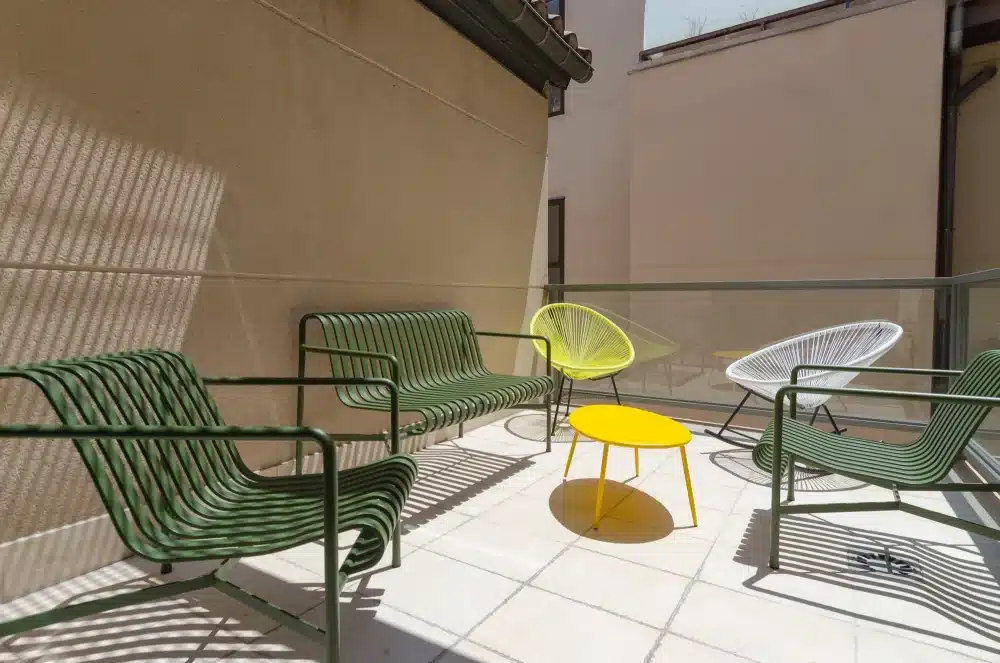 Outdoor terrace at Urban Campus Malasaña Madrid, lounge seating in a shaded patio