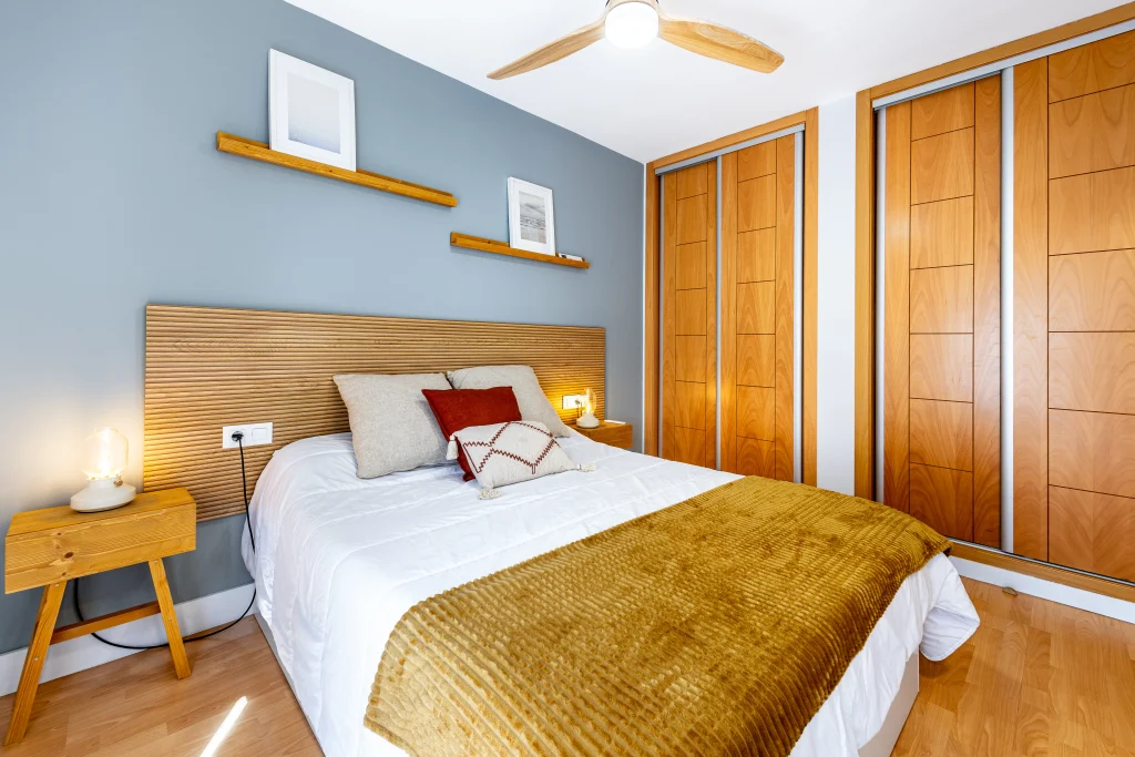 Bedroom at Urban Campus Casajara, Málaga coliving apartment, wood headboard and wardrobe