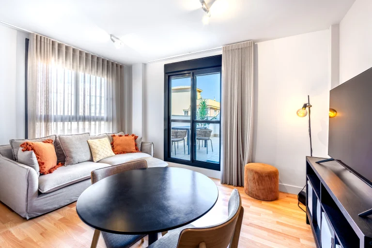Living room with balcony access at Urban Campus Casajara, Málaga coliving apartment