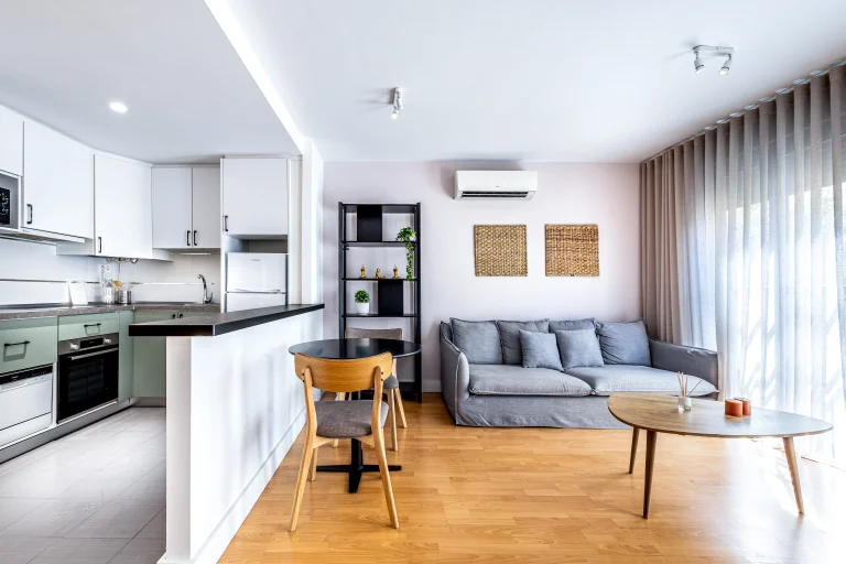 Living room and kitchen at Urban Campus Casajara, Málaga coliving apartment, open-plan layout