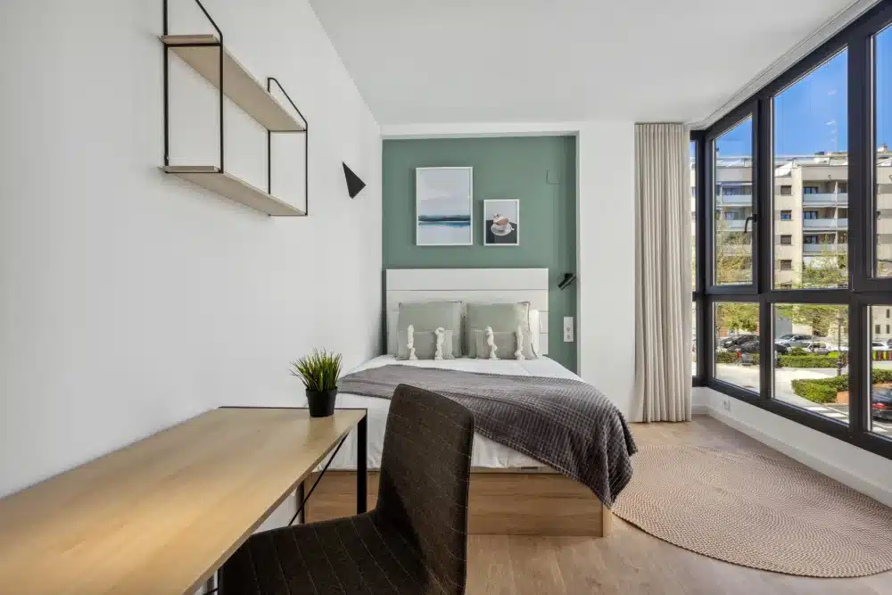 Bedroom at Urban Campus Ayora Coliving in Valencia, with large window and desk