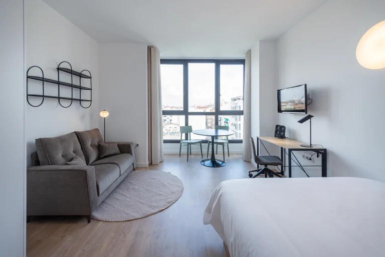 Studio at Urban Campus Ayora Coliving in Valencia, with lounge and desk area