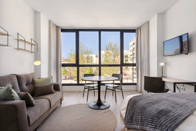 Studio at Urban Campus Ayora Coliving in Valencia, with lounge, dining area and bed