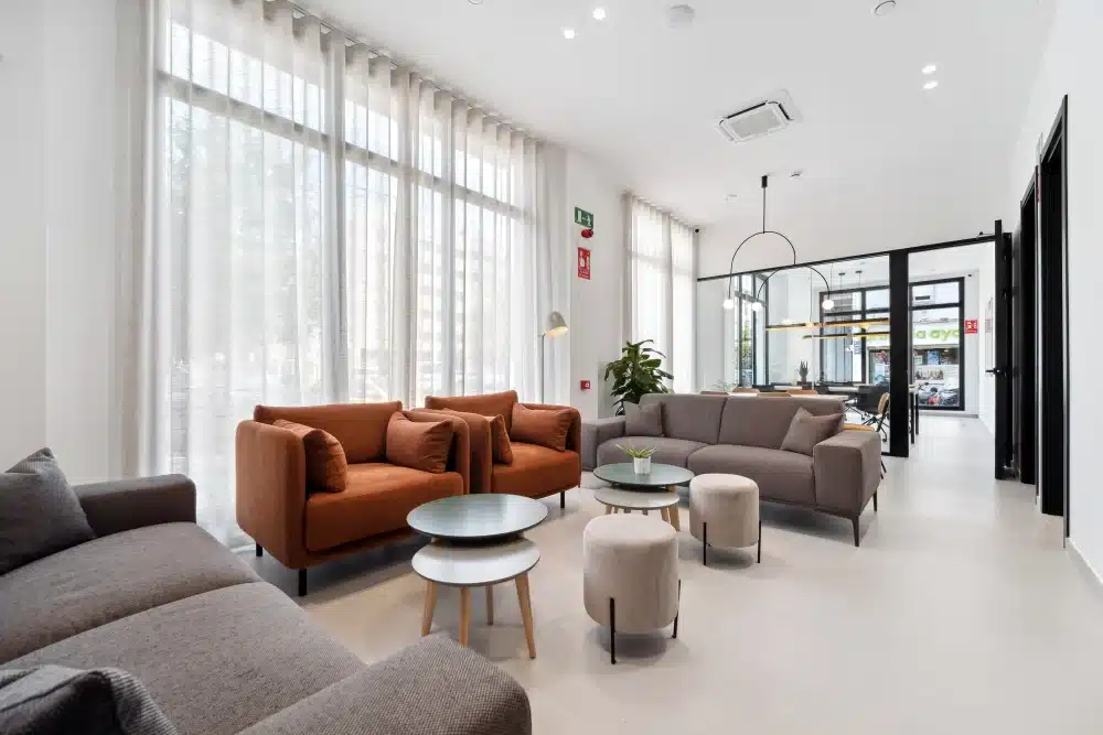 Common lounge at Urban Campus Ayora Coliving in Valencia, sofas and shared relaxation area