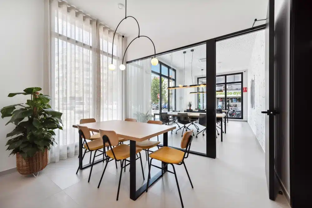 Coworking area at Urban Campus Ayora Coliving in Valencia, shared table and open desks
