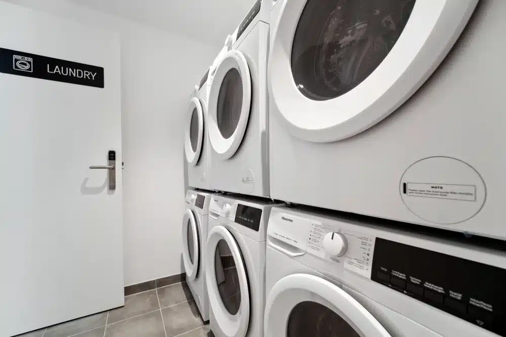 Laundry room at Urban Campus Ayora Coliving in Valencia, shared washers and dryers